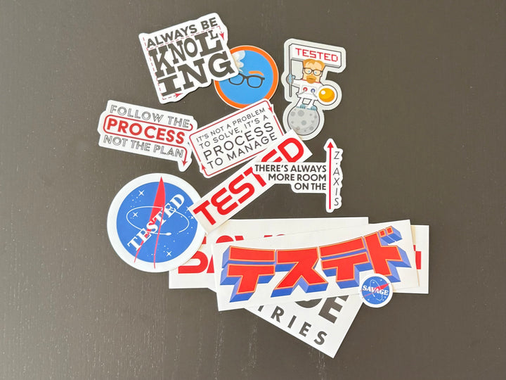 Stickers from the Adam-isms Mega Sticker Pack on a dark surface #mobile
